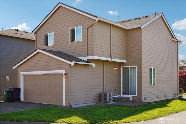 4825 E Q St Unit 2922, Tacoma, WA 98404 - rear view of house featuring central AC unit, asphalt driveway, a garage, and a lawn