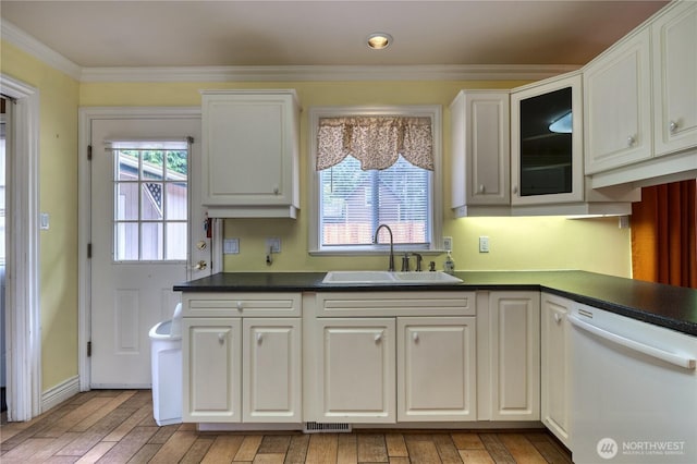 245 Shady Glen Ave, Point Roberts, WA 98281 - kitchen featuring a sink, dishwasher, dark countertops, crown molding, and light wood-type flooring