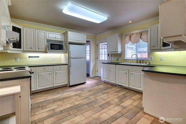 245 Shady Glen Ave, Point Roberts, WA 98281 - kitchen featuring freestanding refrigerator, a sink, black microwave, ornamental molding, and dark countertops