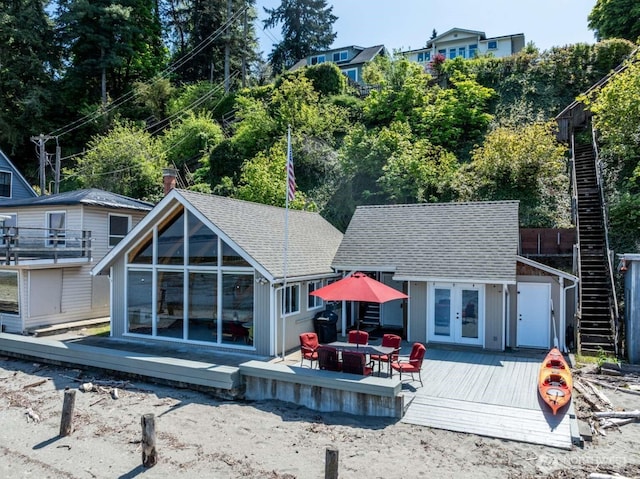 1719 Beach Dr NE, Tacoma, WA 98422 - back of property featuring a wooden deck, a shingled roof, an outbuilding, and french doors