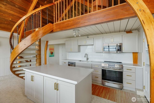 1719 Beach Dr NE, Tacoma, WA 98422 - kitchen featuring stainless steel appliances, a sink, wooden ceiling, light countertops, and a center island