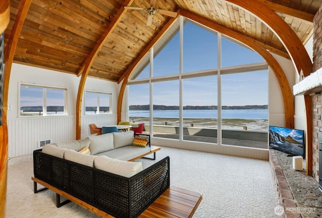 1719 Beach Dr NE, Tacoma, WA 98422 - living area with carpet, a water view, wooden ceiling with exposed beams, and high vaulted ceiling