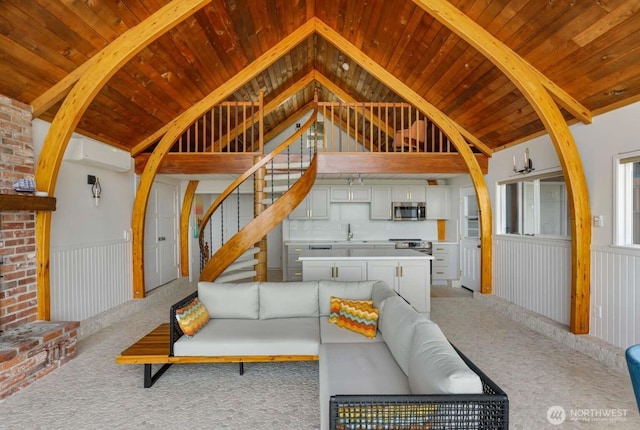 1719 Beach Dr NE, Tacoma, WA 98422 - living room featuring lofted ceiling, wooden ceiling, carpet, wainscoting, and stairway
