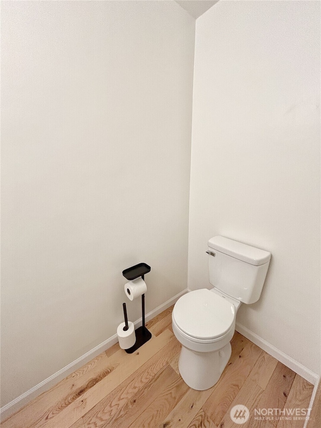 2648 Erwin Ave, Dupont, WA 98327 - bathroom featuring wood finished floors, toilet, and baseboards