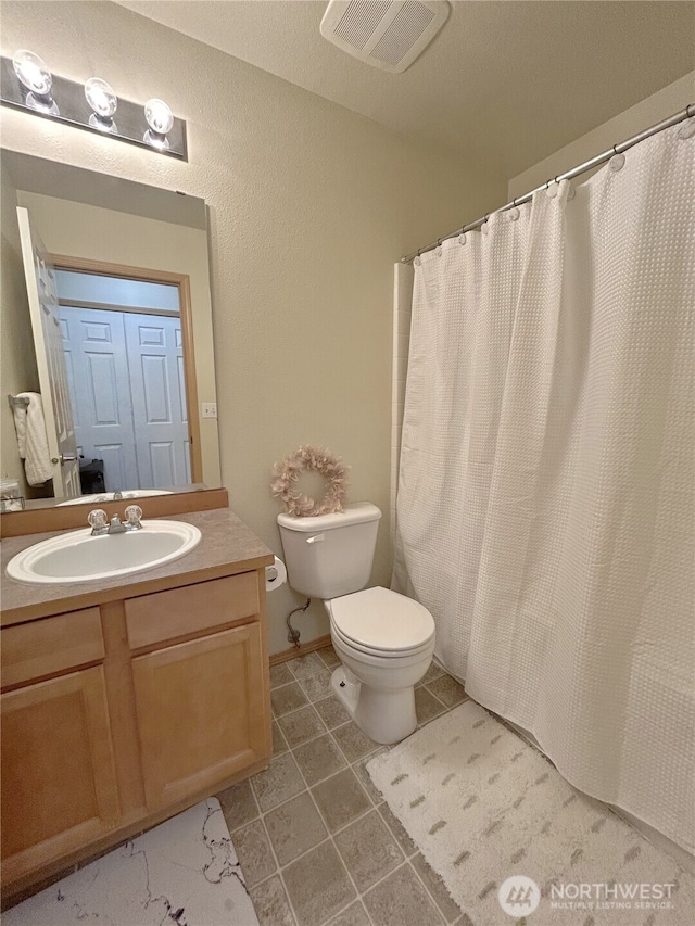 2648 Erwin Ave, Dupont, WA 98327 - bathroom featuring toilet, vanity, and tile patterned floors