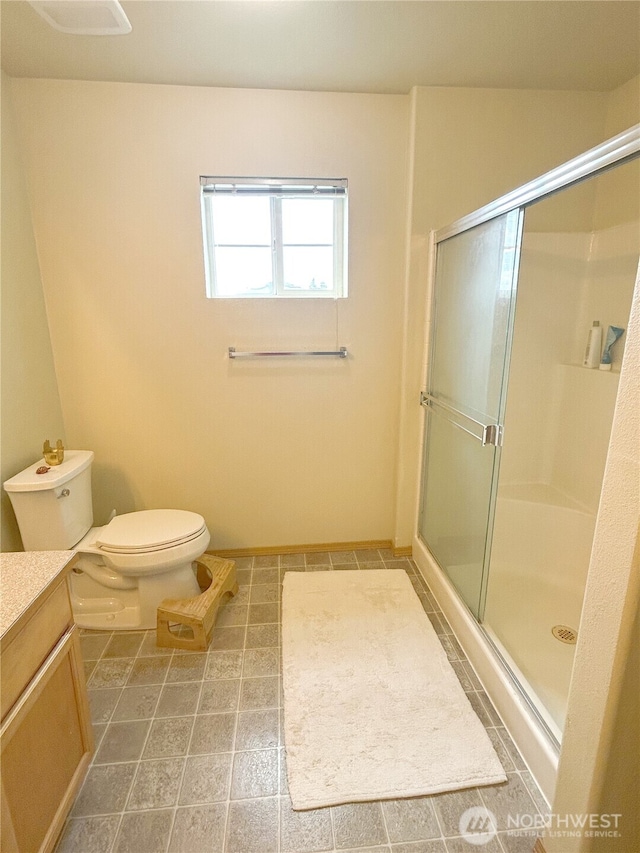 2648 Erwin Ave, Dupont, WA 98327 - bathroom featuring a shower with door, vanity, toilet, and baseboards