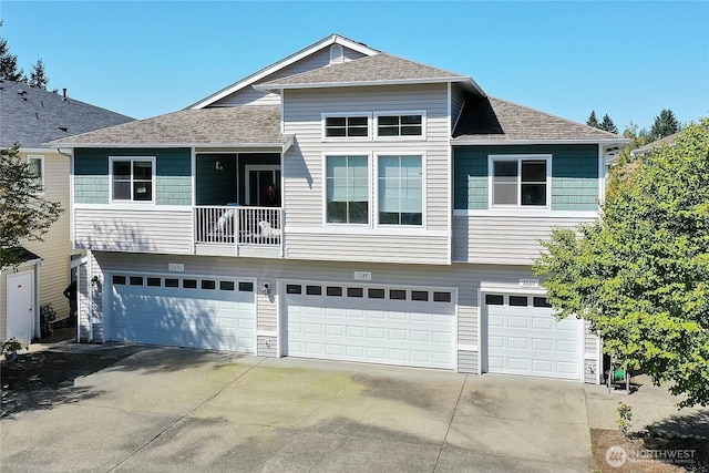 2648 Erwin Ave, Dupont, WA 98327 - view of front of home featuring a garage, driveway, and a shingled roof