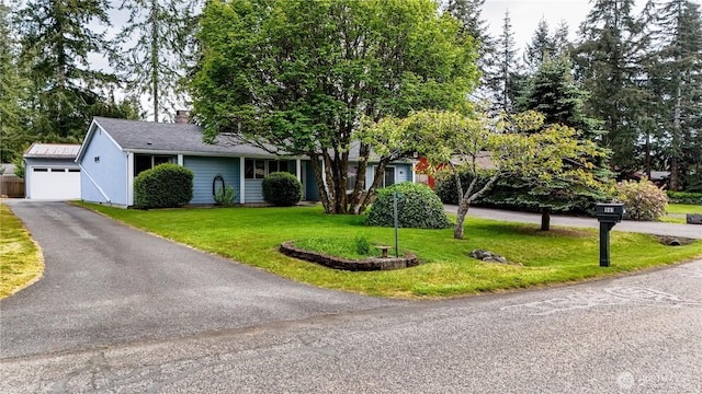 961 Robin Hood Loop, Forks, WA 98331 - view of front of home featuring a front lawn, a chimney, and a detached garage