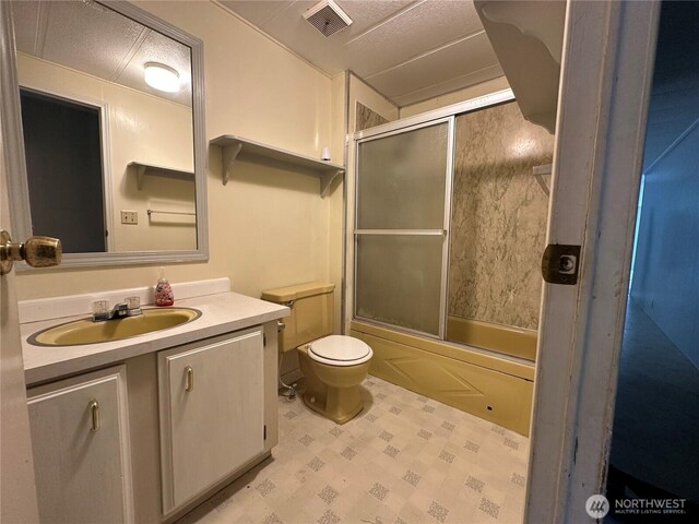 11615 Nisqually Park Loop SE, Olympia, WA 98513 - bathroom featuring toilet, vanity, and bath / shower combo with glass door