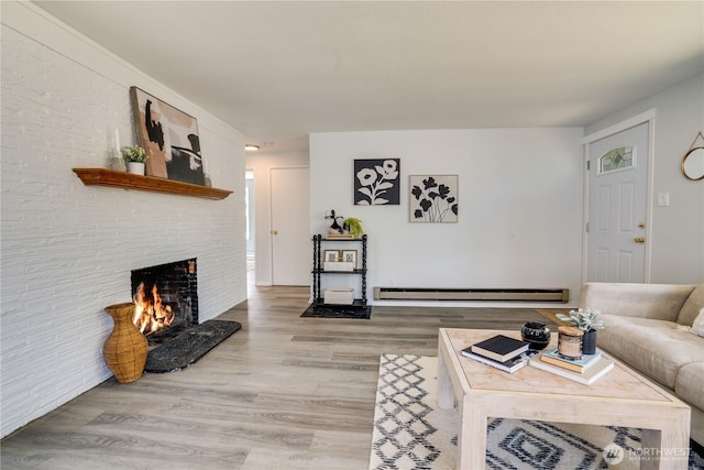 1108 116th St S, Tacoma, WA 98444 - living area featuring a baseboard radiator, a brick fireplace, and wood finished floors