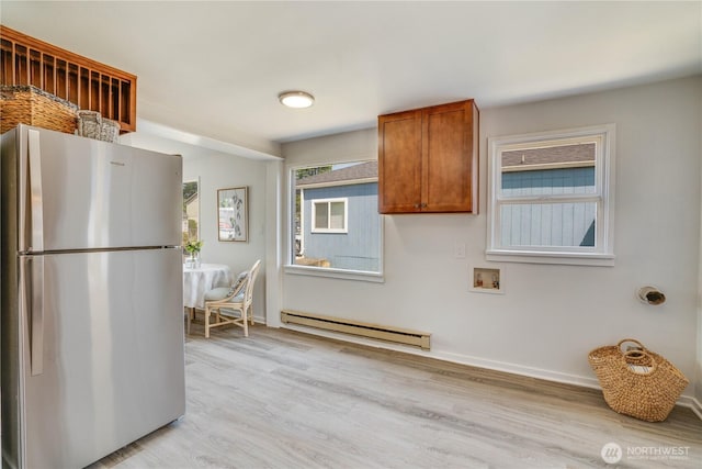 1108 116th St S, Tacoma, WA 98444 - kitchen featuring freestanding refrigerator, a baseboard heating unit, light wood finished floors, and brown cabinets