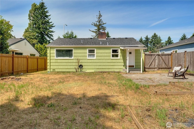 1108 116th St S, Tacoma, WA 98444 - rear view of property with a fenced backyard, a chimney, and roof with shingles