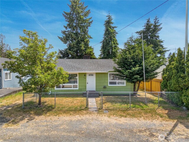 1108 116th St S, Tacoma, WA 98444 - view of front facade featuring a fenced front yard, roof with shingles, and a chimney