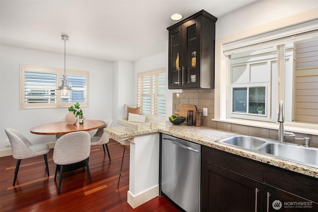 3122 Franklin Ave E Unit A, Seattle, WA 98102 - kitchen featuring stainless steel dishwasher, a sink, dark wood-type flooring, decorative backsplash, and baseboards