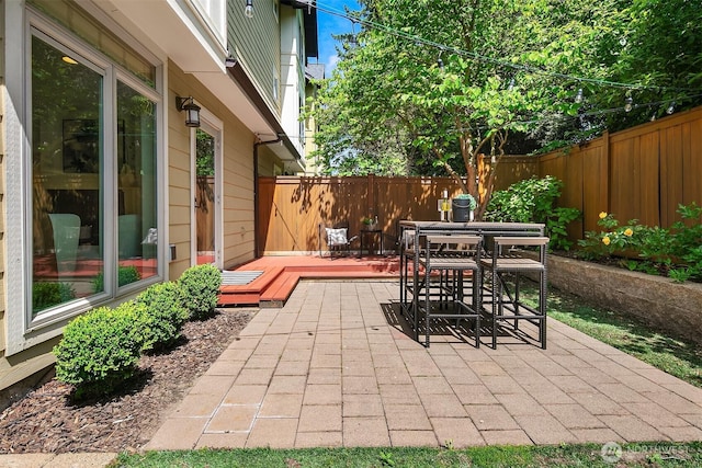 3122 Franklin Ave E Unit A, Seattle, WA 98102 - fenced backyard with a wooden deck, outdoor dining area, and a patio