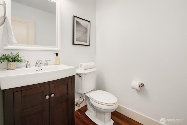 3122 Franklin Ave E Unit A, Seattle, WA 98102 - bathroom featuring wood finished floors, toilet, vanity, and baseboards