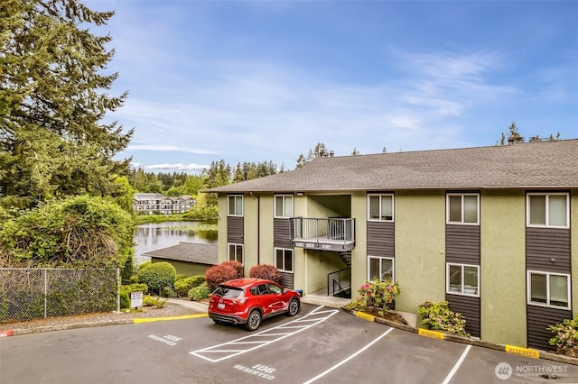 615 75th St SE Unit C-44, Everett, WA 98203 - view of building exterior featuring uncovered parking and a water view