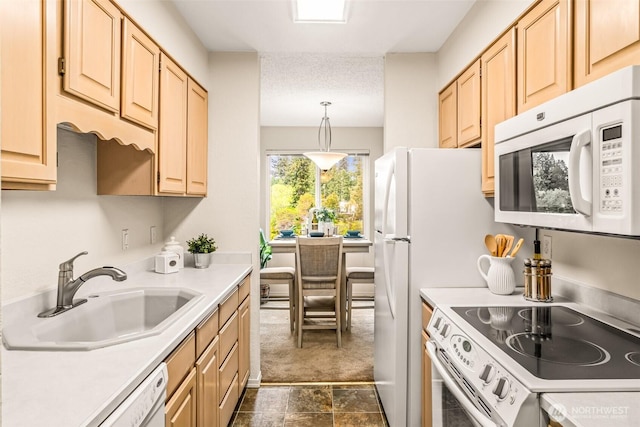 615 75th St SE Unit C-44, Everett, WA 98203 - kitchen featuring white appliances, a sink, light brown cabinets, and light countertops