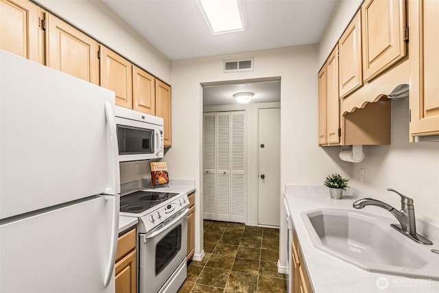 615 75th St SE Unit C-44, Everett, WA 98203 - kitchen with white appliances, light brown cabinets, light countertops, a sink, and dark stone finish flooring