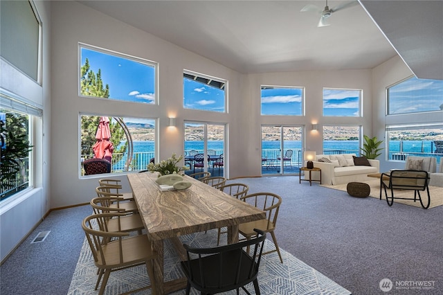 4270 US Highway 97a, Chelan, WA 98816 - dining area with carpet flooring, a towering ceiling, a ceiling fan, and baseboards