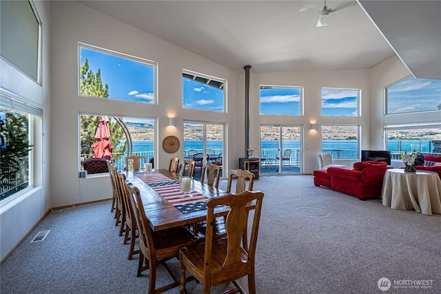 4270 US Highway 97a, Chelan, WA 98816 - dining space with carpet, high vaulted ceiling, baseboards, ceiling fan, and a water view