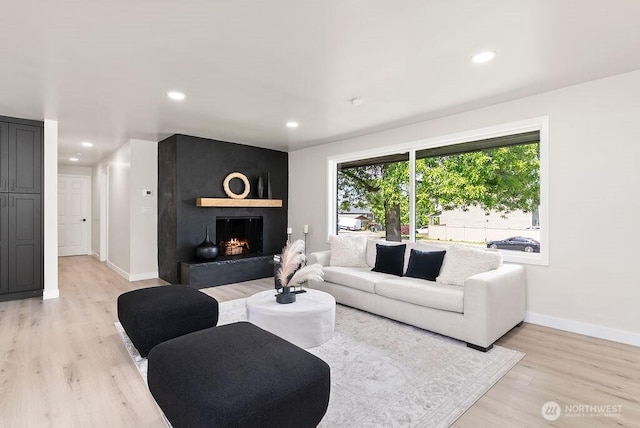 11433 SE 244th St, Kent, WA 98030 - living area with light wood-type flooring, baseboards, a fireplace, and recessed lighting