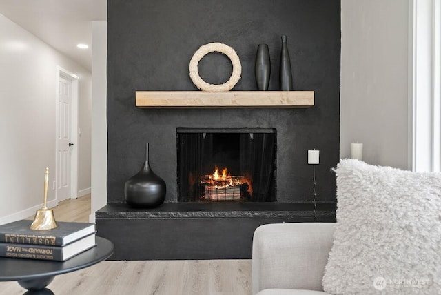 11433 SE 244th St, Kent, WA 98030 - detailed view of wood finished floors, a lit fireplace, recessed lighting, and baseboards