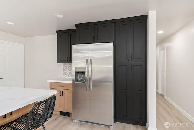 11433 SE 244th St, Kent, WA 98030 - kitchen featuring stainless steel fridge with ice dispenser, light wood finished floors, light stone counters, tasteful backsplash, and recessed lighting