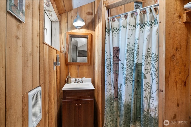 622 Wagon Wheel Rd, Cle Elum, WA 98922 - bathroom featuring heating unit, vanity, wood walls, and curtained shower