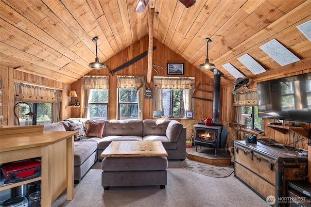 622 Wagon Wheel Rd, Cle Elum, WA 98922 - carpeted living room with wood ceiling, wood walls, a wood stove, lofted ceiling, and plenty of natural light