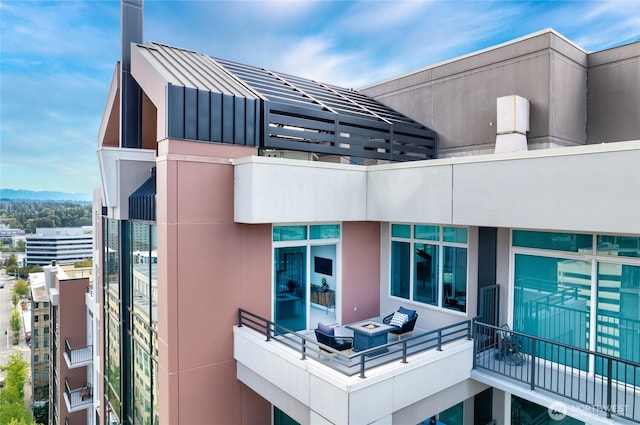 177 107th Ave NE Unit 2401, Bellevue, WA 98004 - rear view of property with a balcony and a standing seam roof