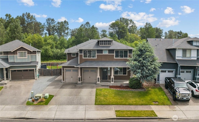 317 Phoenix Ave SW, Orting, WA 98360 - view of front facade with driveway, a porch, a garage, and a shingled roof