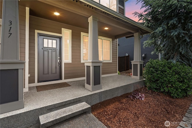 317 Phoenix Ave SW, Orting, WA 98360 - exterior entry at dusk featuring a porch