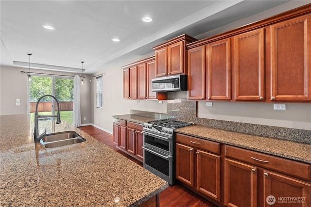 317 Phoenix Ave SW, Orting, WA 98360 - kitchen with appliances with stainless steel finishes, a sink, dark wood-style floors, recessed lighting, and hanging light fixtures