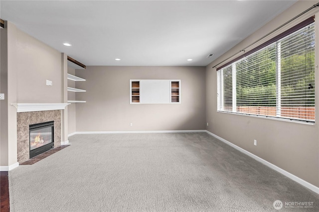 317 Phoenix Ave SW, Orting, WA 98360 - unfurnished living room with carpet floors, a fireplace, baseboards, and recessed lighting