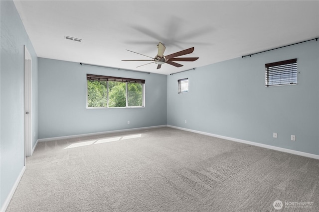 317 Phoenix Ave SW, Orting, WA 98360 - spare room featuring ceiling fan, carpet floors, and baseboards