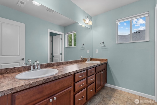 317 Phoenix Ave SW, Orting, WA 98360 - bathroom featuring baseboards and double vanity