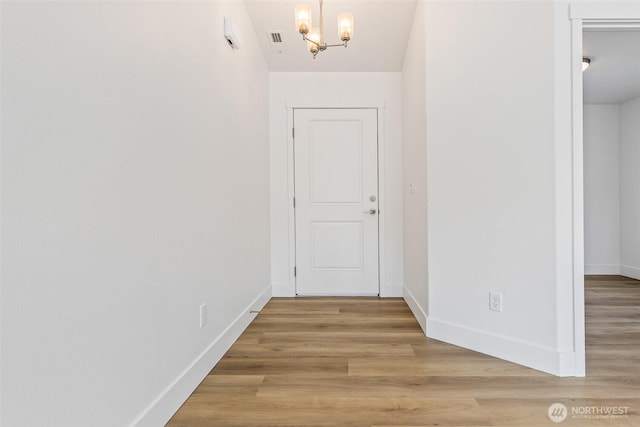 217 N Sandy Loop, Moses Lake, WA 98837 - hallway featuring a chandelier and light wood finished floors