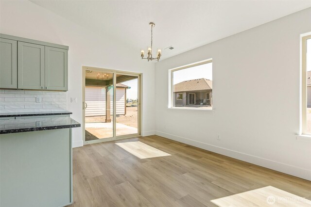 217 N Sandy Loop, Moses Lake, WA 98837 - unfurnished dining area with a chandelier and light wood-type flooring