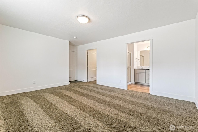 217 N Sandy Loop, Moses Lake, WA 98837 - unfurnished bedroom featuring light carpet and ensuite bath