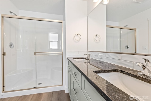 217 N Sandy Loop, Moses Lake, WA 98837 - bathroom with a stall shower, double vanity, and wood finished floors