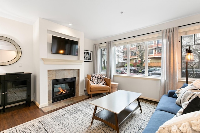1525 NW 57th St Unit 109, Seattle, WA 98107 - living area featuring a tile fireplace, wood finished floors, baseboards, and recessed lighting