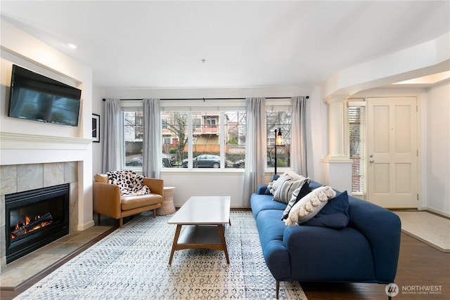 1525 NW 57th St Unit 109, Seattle, WA 98107 - living room featuring ornate columns, a fireplace, wood finished floors, and healthy amount of natural light