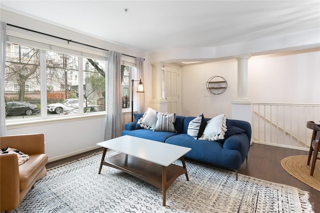 1525 NW 57th St Unit 109, Seattle, WA 98107 - living area with decorative columns, wood finished floors, and healthy amount of natural light