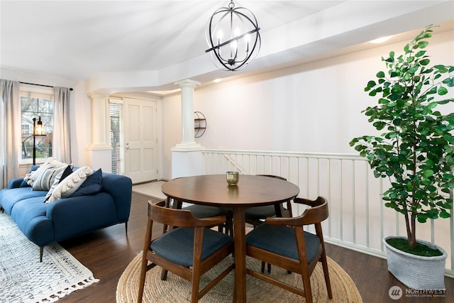 1525 NW 57th St Unit 109, Seattle, WA 98107 - dining area with decorative columns, dark wood-style floors, and a chandelier
