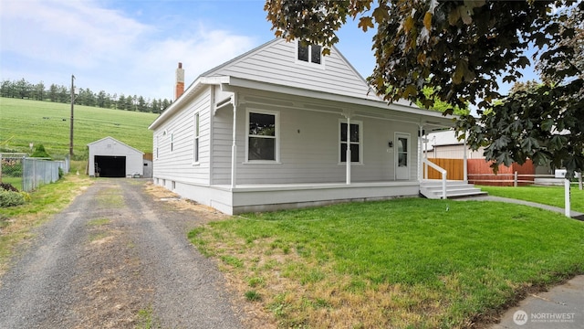427 E Dayton Ave, Dayton, WA 99328 - view of front of home with driveway, an outdoor structure, a porch, a chimney, and a detached garage