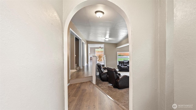 427 E Dayton Ave, Dayton, WA 99328 - corridor featuring arched walkways, a textured wall, and wood finished floors