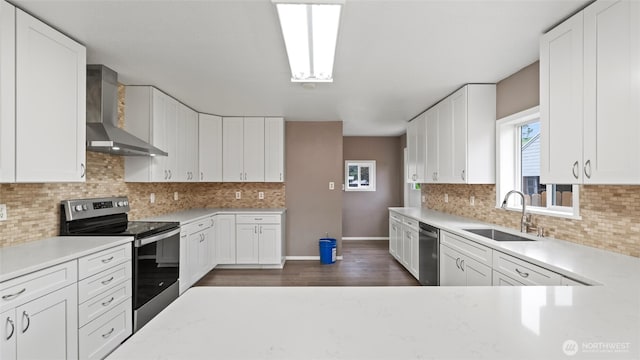 427 E Dayton Ave, Dayton, WA 99328 - kitchen with wall chimney range hood, appliances with stainless steel finishes, a sink, baseboards, and light countertops