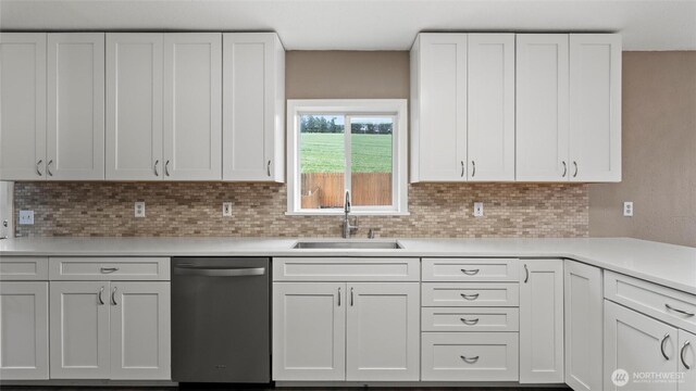 427 E Dayton Ave, Dayton, WA 99328 - kitchen featuring stainless steel dishwasher, a sink, light countertops, backsplash, and white cabinetry