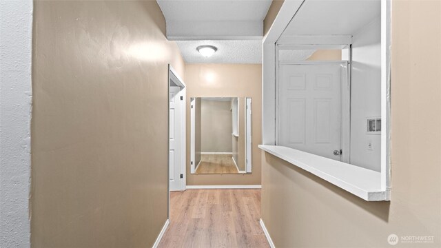 427 E Dayton Ave, Dayton, WA 99328 - corridor with light wood-type flooring, baseboards, and a textured ceiling